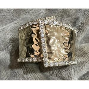 Gold tone hammered cuff bracelet with Chrystal rhinestones. Size 7. Front opens